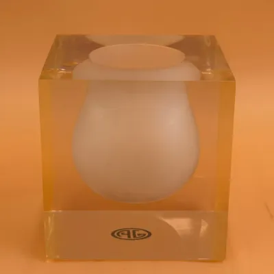 Sale Photo Thumbnail #79: Vintage clear acrylic cube vase featuring a frosted glass urn-shaped vessel suspended inside, marked with a circular logo on the base.
