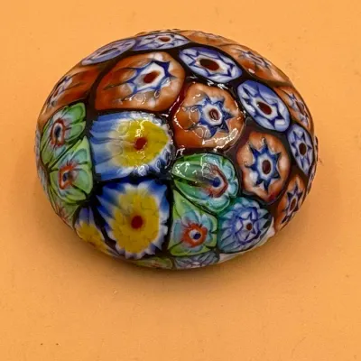 Sale Photo Thumbnail #66: Vintage Murano millefiori art glass paperweight, featuring a colorful dome of intricate floral canes in blue, yellow, green, and orange.
