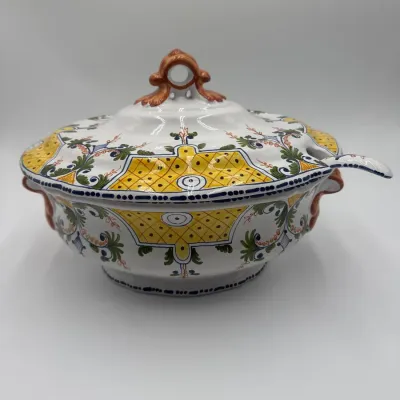Sale Photo Thumbnail #70: Italian majolica ceramic soup tureen with lid and matching ladle, featuring hand-painted yellow, green, and orange scrollwork and geometric patterns.