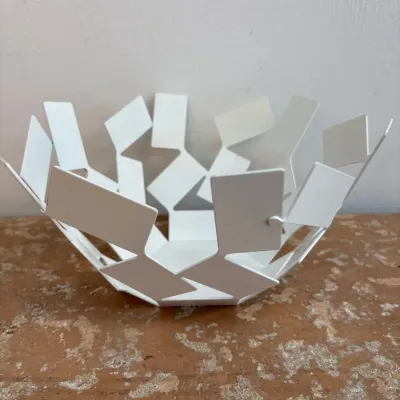 Sale Photo Thumbnail #160: Alessi "La Stanza dello Scirocco" white steel fruit bowl, designed by Mario Trimarchi, featuring a geometric, fragmented card-like design.