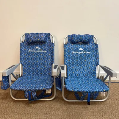 Sale Photo Thumbnail #146: Pair of Tommy Bahama folding backpack beach chairs featuring a blue and yellow geometric pattern, built-in pillows, and cup holders.