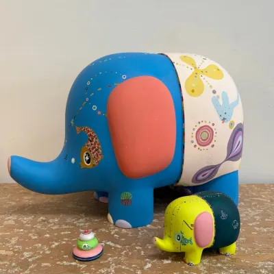 Sale Photo Thumbnail #94: Whimsical painted elephant figurines, featuring a large blue elephant with colorful patterns and a smaller coordinating yellow and green elephant.