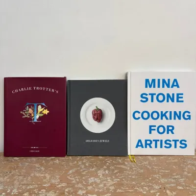 Sale Photo Thumbnail #88: Three hardcover cookbooks standing upright, including "Charlie Trotter's," "Delicious Jewels," and Mina Stone's "Cooking for Artists."