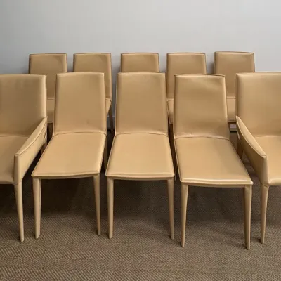 Sale Photo Thumbnail #34: Set of ten modern Italian dining chairs upholstered in beige leather, including two armchairs and eight side chairs.