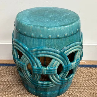 Sale Photo Thumbnail #125: Chinese-style ceramic garden stool featuring a vibrant turquoise glaze, openwork interlocking ring design, and raised stud details.