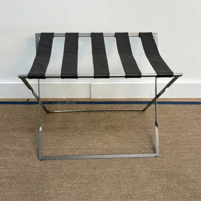 Sale Photo Thumbnail #119: Modern folding luggage rack featuring a brushed metal frame and five wide black straps.
