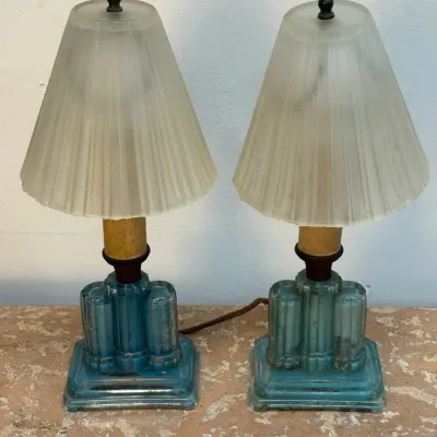 Sale Photo Thumbnail #159: Pair of Art Deco boudoir lamps featuring blue glass skyscraper-style bases and frosted, ribbed glass shades.