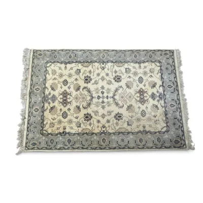 Sale Photo Thumbnail #300: Hand-knotted wool area rug featuring a traditional floral design in a muted palette of cream, grey, and beige with fringed ends.