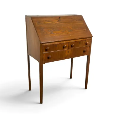 Sale Photo Thumbnail #81: Antique slant-front writing desk in a warm wood finish, featuring a drop-down writing surface, three drawers with wooden knobs, and tall, tapered legs.