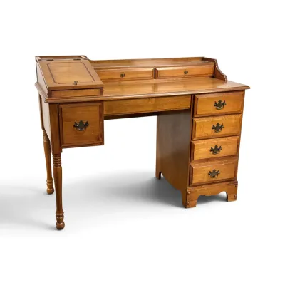 Sale Photo Thumbnail #125: Vintage maple spinet desk featuring a lift-top storage compartment, small upper drawers, and a five-drawer configuration with brass batwing pulls.