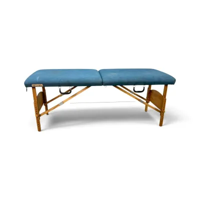 Sale Photo Thumbnail #165: Special Touch portable massage table with a blue vinyl padded top and adjustable wooden legs.