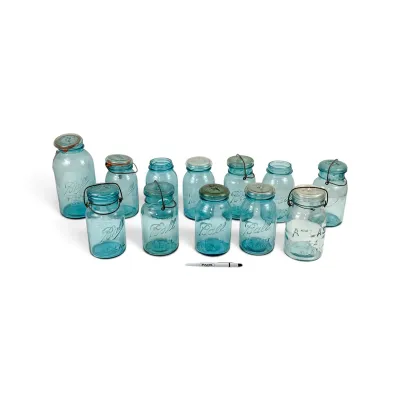 Sale Photo Thumbnail #35: Collection of eleven vintage blue glass canning jars, including Ball Perfect Mason, Ball Ideal, and Atlas E-Z Seal styles, some with wire bail closures and glass lids.