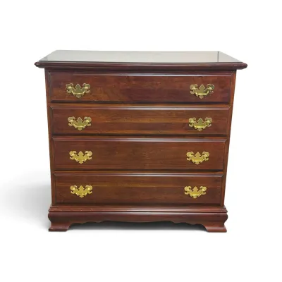 Sale Photo Thumbnail #63: Vintage Chippendale-style cherry wood bachelor's chest featuring four drawers with brass batwing pulls and a bracket base.