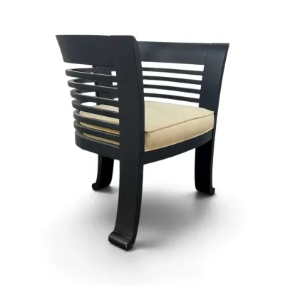 Sale Photo Thumbnail #107: Contemporary black-finished wooden barrel chair featuring a slatted backrest and a beige upholstered seat cushion.