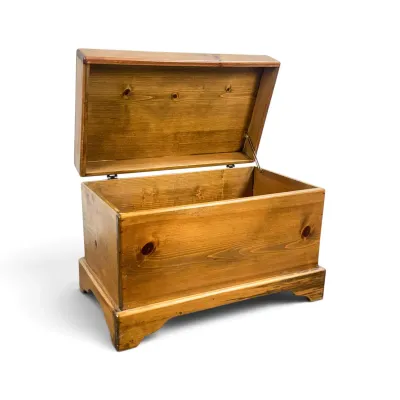 Sale Photo Thumbnail #46: Rustic knotty pine blanket chest with a hinged lid, bracket feet, and a warm honey finish.