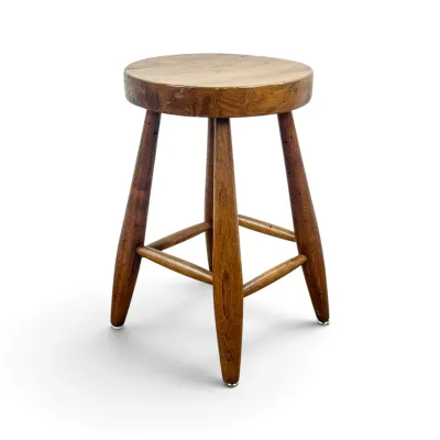 Sale Photo Thumbnail #33: Vintage rustic wooden stool featuring a thick round seat, four tapered legs, and a cross-brace stretcher.
