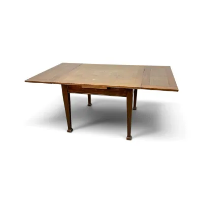 Sale Photo Thumbnail #162: Vintage wooden draw-leaf dining table with tapered legs, showing some surface wear on the tabletop.