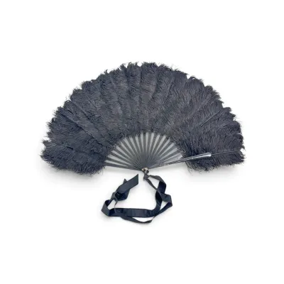Sale Photo Thumbnail #39: Vintage black ostrich feather folding hand fan with dark sticks and an attached black ribbon loop.