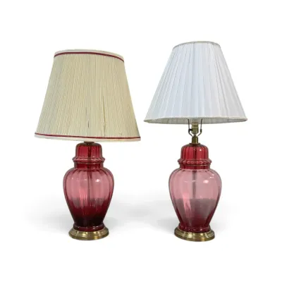 Sale Photo Thumbnail #208: Pair of mid-century cranberry glass ginger jar table lamps with brass bases and pleated fabric shades.
