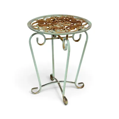 Sale Photo Thumbnail #251: Vintage wrought iron garden side table featuring a pale green painted finish with heavy rust patina and a decorative scrollwork top.