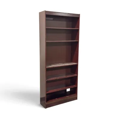Sale Photo Thumbnail #269: Tall dark reddish-brown wooden bookcase with adjustable shelves, showing some wear and scuffs from use.