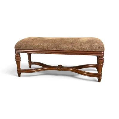 Sale Photo Thumbnail #85: Traditional upholstered bench featuring a carved wooden frame with a curved X-stretcher and patterned fabric seat.