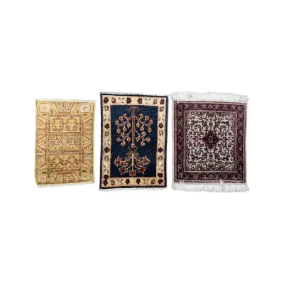 Sale Photo Thumbnail #295: Three miniature Persian-style rugs featuring intricate geometric, tree of life, and floral medallion patterns in gold, navy, and burgundy hues.