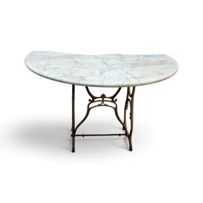 Sale Photo Thumbnail #207: Kidney-shaped white marble top table supported by an ornate cast iron base with decorative scrollwork.