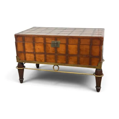 Sale Photo Thumbnail #17: Maitland-Smith style leather-wrapped trunk on a brass-mounted stand, featuring a grid pattern, fluted legs, and a brass stretcher.