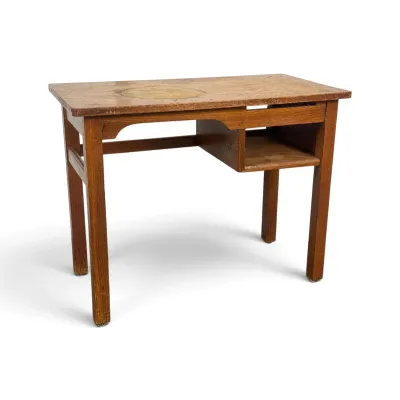 Sale Photo Thumbnail #89: Vintage wooden student desk featuring a single open storage cubby and showing significant wear and staining on the top surface.