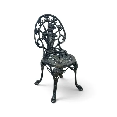 Sale Photo Thumbnail #230: Vintage black cast iron garden chair featuring an ornate iris floral motif on the backrest and a pierced circular seat.