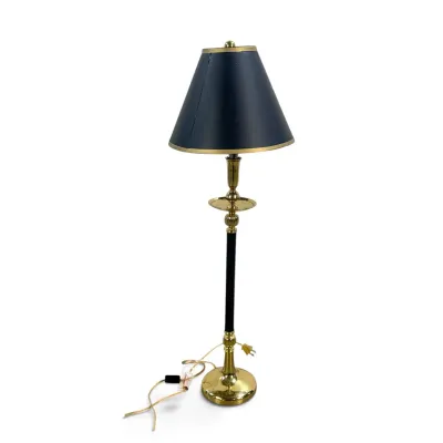Sale Photo Thumbnail #278: Vintage Stiffel-style brass and black metal buffet lamp, featuring a slender column, circular tray detail, and a black paper shade with gold trim.