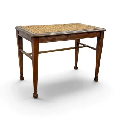 Sale Photo Thumbnail #281: Vintage wooden side table featuring a woven cane top insert, tapered legs with H-stretcher support, and a warm brown finish.