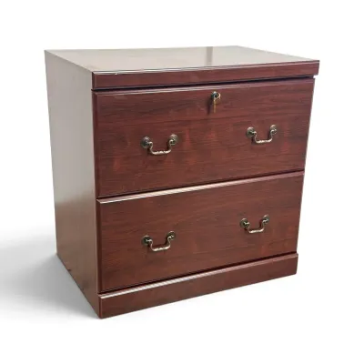 Sale Photo Thumbnail #115: Two-drawer lateral file cabinet in a cherry wood finish, featuring traditional brass bail pulls and a top drawer lock with key.