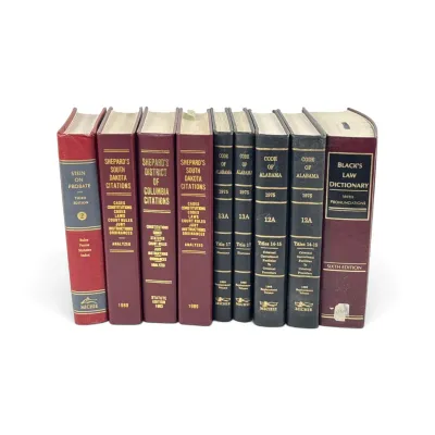 Sale Photo Thumbnail #38: Collection of vintage law books, including Black's Law Dictionary Sixth Edition, Shepard's Citations, and Code of Alabama volumes, showing some wear from use.