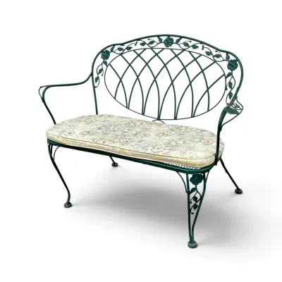 Sale Photo Thumbnail #240: Vintage green wrought iron garden bench featuring a decorative lattice back with floral accents and a removable floral patterned cushion.
