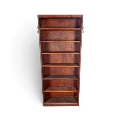 Sale Photo Thumbnail #273: Vintage dark-stained wooden bookshelf featuring seven fixed shelves and small metal hooks mounted on the upper sides.