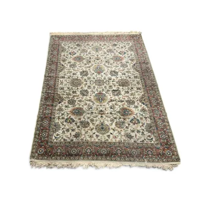 Sale Photo Thumbnail #305: Traditional Persian-style area rug featuring an intricate floral design on an ivory field with a contrasting reddish-brown border and fringed ends.