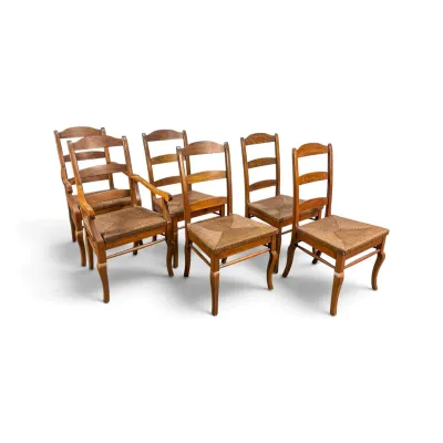 Sale Photo Thumbnail #104: Set of six French Country style ladderback dining chairs, including one armchair and five side chairs, featuring woven rush seats and cabriole front legs.