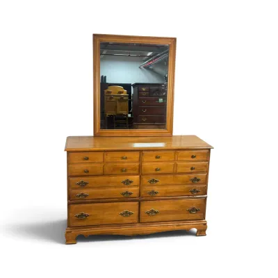 Sale Photo Thumbnail #2: Vintage solid wood double dresser with matching landscape mirror, featuring brass batwing drawer pulls and bracket feet.