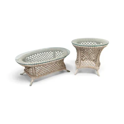 Sale Photo Thumbnail #197: Two-piece white wicker living room table set, including an oval coffee table and a round side table, both featuring open lattice bases and glass tops.