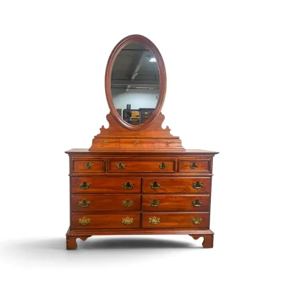 Sale Photo Thumbnail #61: Chippendale-style cherry wood dresser featuring a detachable oval mirror, three small jewelry drawers, and nine larger drawers with brass batwing pulls.