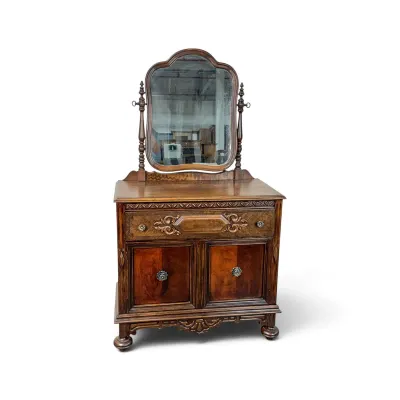 Sale Photo Thumbnail #136: Antique Eastlake-style walnut washstand with a swivel mirror, featuring a single carved drawer over a two-door lower cabinet.