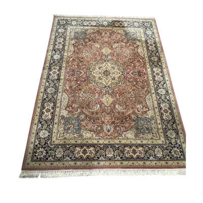 Sale Photo Thumbnail #306: Traditional Persian-style area rug featuring an intricate central medallion, floral motifs in shades of rose, cream, and navy, and a fringed border.