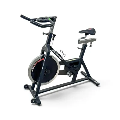 Sale Photo Thumbnail #241: Schwinn Spinner indoor stationary exercise bike with a black steel frame, adjustable seat and handlebars, and a heavy front flywheel.