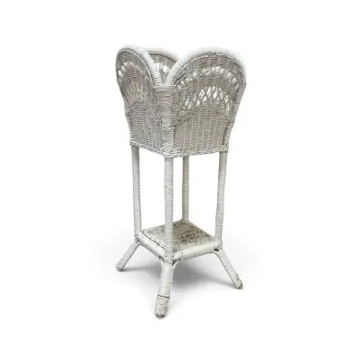 Sale Photo Thumbnail #191: Vintage white wicker planter stand featuring a scalloped top with bead details and a lower shelf, showing some light wear.