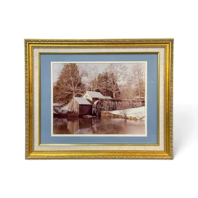Sale Photo Thumbnail #321: Framed landscape print depicting a snow-covered gristmill by a river, housed in an ornate gilt frame with blue and linen matting.