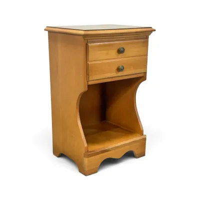 Sale Photo Thumbnail #186: Vintage maple nightstand featuring two upper drawers with round metal pulls, a large open lower storage compartment, and curved side panels.
