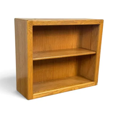 Sale Photo Thumbnail #97: Low oak bookcase featuring a single adjustable shelf and a warm, natural wood finish, circa late 20th century.