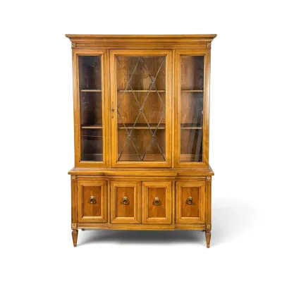 Sale Photo Thumbnail #142: Vintage one-piece wooden hutch featuring a glass-front display cabinet with diamond-patterned leaded glass on the center door, set atop a credenza base with four cabinet doors and brass ring pulls.